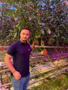 Andrei Mihai Showing Tomatoes at Steiner Greenhouse